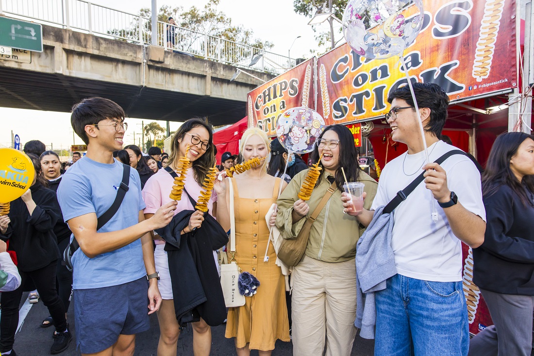 2024-Cabramatta-Moon-Festival-group-eating-chips-on-a-stick-by-Anna-Kucera.jpg